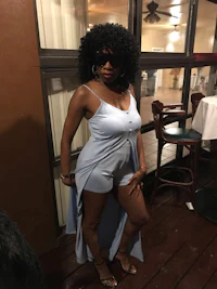 a woman in a blue dress posing for a picture