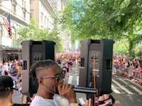a man is holding a microphone in front of a crowd of people