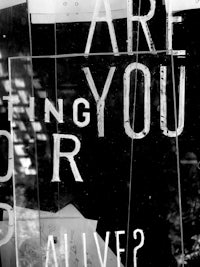 a black and white photo of a sign that says are you alive?