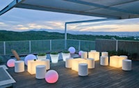 a group of white vases on a wooden deck at dusk