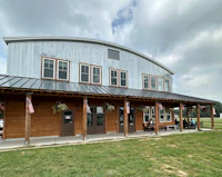 a building with a metal roof and a flag on it