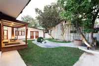 a house with a large yard and a wooden deck