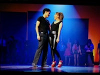 a man and a woman standing on a stage