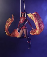 a woman performing acrobatics on a rope