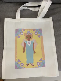 a tote bag with a doll on it