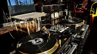 a dj set up in a bar with a laptop