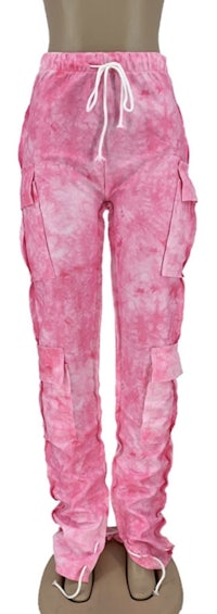 a pair of pink tie dye cargo pants on a mannequin mannequin