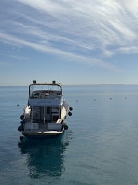 a boat is floating in a calm body of water
