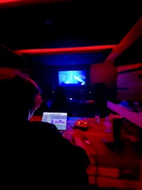 a man is working on a laptop in a dark room