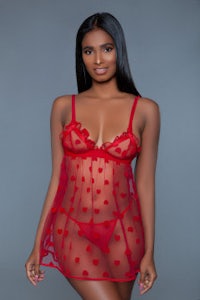 a woman in a red lingerie set posing for a photo