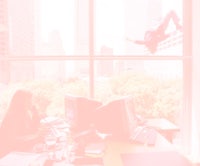 a woman is sitting at a desk in an office