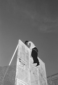 a skateboarder doing a trick on a wall