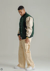 a man wearing a tan jacket and khaki pants