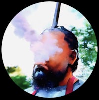 a man with a beard is smoking a pipe
