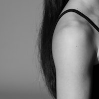 a black and white photo of a woman with long hair