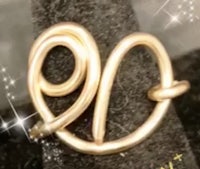 a gold ring with the letter o on it