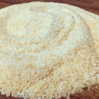 a bowl of granulated sugar on a wooden table