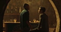two men in a bar talking to each other