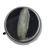 a rock is sitting on top of a metal plate