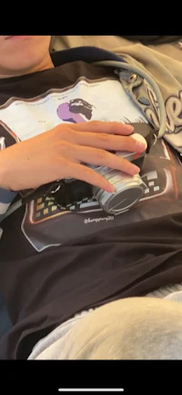 a person laying on a bed with a phone in their hand