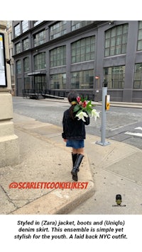 a girl walking down the street with flowers in her hands