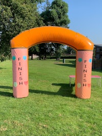 an inflatable arch in a grassy field