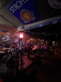 a group of people playing music in a bar