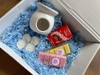 a box containing a candle and some other items