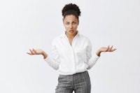 a woman in a white shirt is standing with her hands out