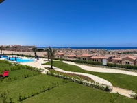 a view from the balcony of a villa overlooking the sea