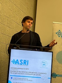 a man giving a speech at a podium
