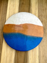 a blue and orange coaster on a wooden table