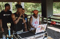 a group of people standing in front of a dj booth