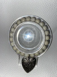 a clear cup with pearls on it