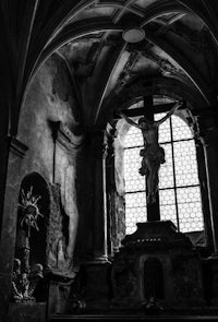 a black and white photo of a church with a cross