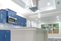 a kitchen with blue cabinets