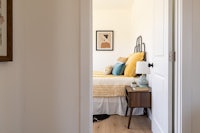 a bedroom with a bed and a bedside table