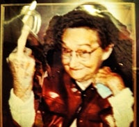 a picture of an old woman holding a knife