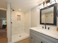 a bathroom with a shower and sink