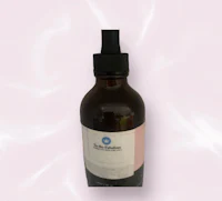 a bottle of rosehip oil on a white background