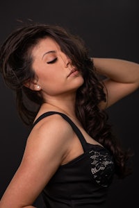 a beautiful woman with long hair posing on a black background