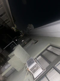 an air conditioner on the side of a building at night
