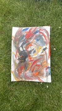 an abstract painting on a piece of grass