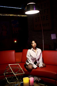 a woman sitting on a red couch
