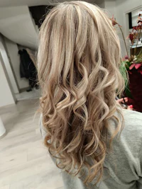 the back of a blonde woman's hair in a salon