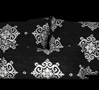 three black and white pillows on a black background
