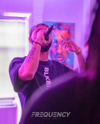 a man is singing into a microphone at a party