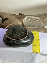 a rock with a measuring tape next to it