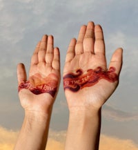 a woman's hands are painted with the words 'love' and'sacrifice'
