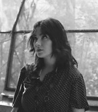 a black and white photo of a woman in a polka dot dress